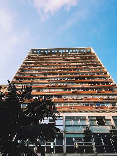 high rise orange and white painted high-rise building porto alegre